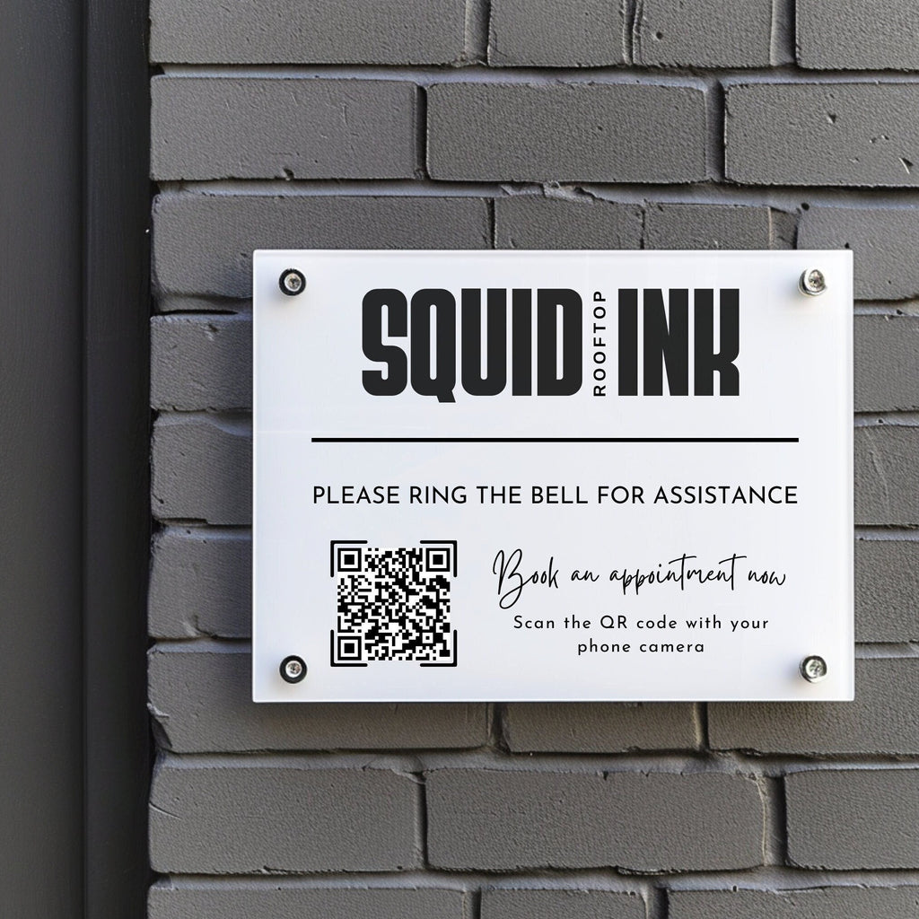 business logo and appointment booking qr code printed on to a acrylic sign that is mounted to the wall using standoff fixings