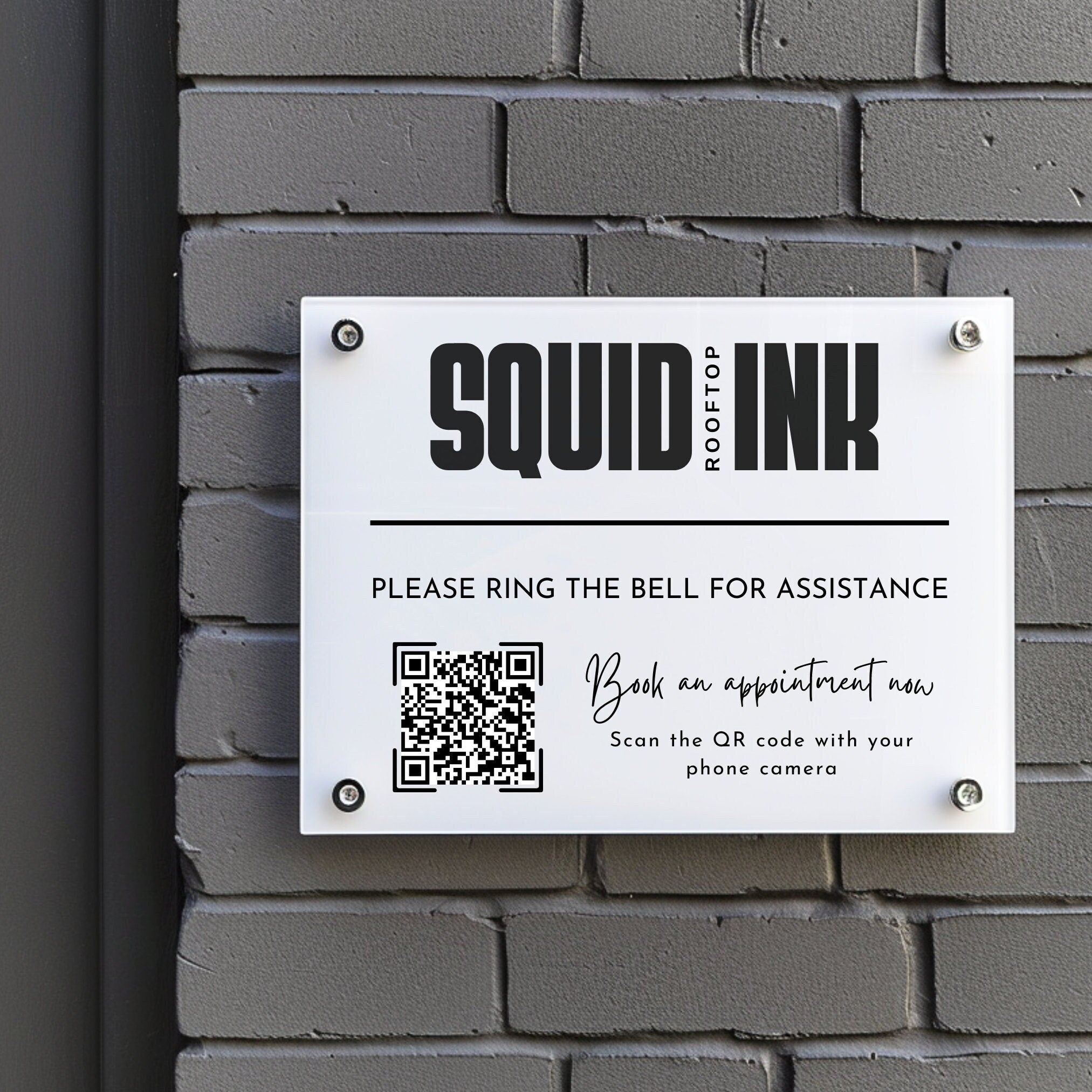 business logo and appointment booking qr code printed on to a acrylic sign that is mounted to the wall using standoff fixings