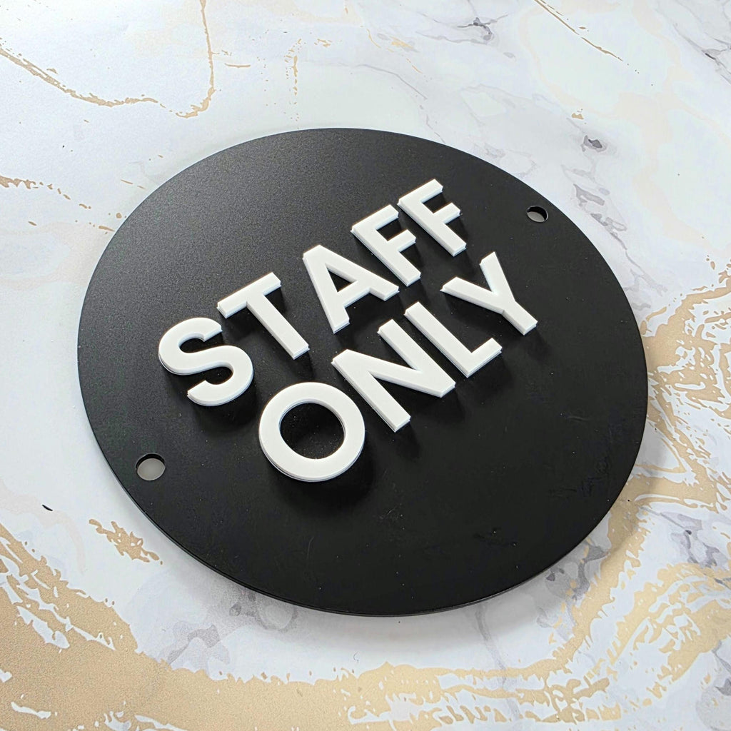 Wall-mounted matte black acrylic STAFF ONLY door sign with a modern white 3D acrylic lettering. Features silver standoff fixings for easy installation. Available in multiple colourways. Ideal for businesses, restaurants, offices, public washrooms