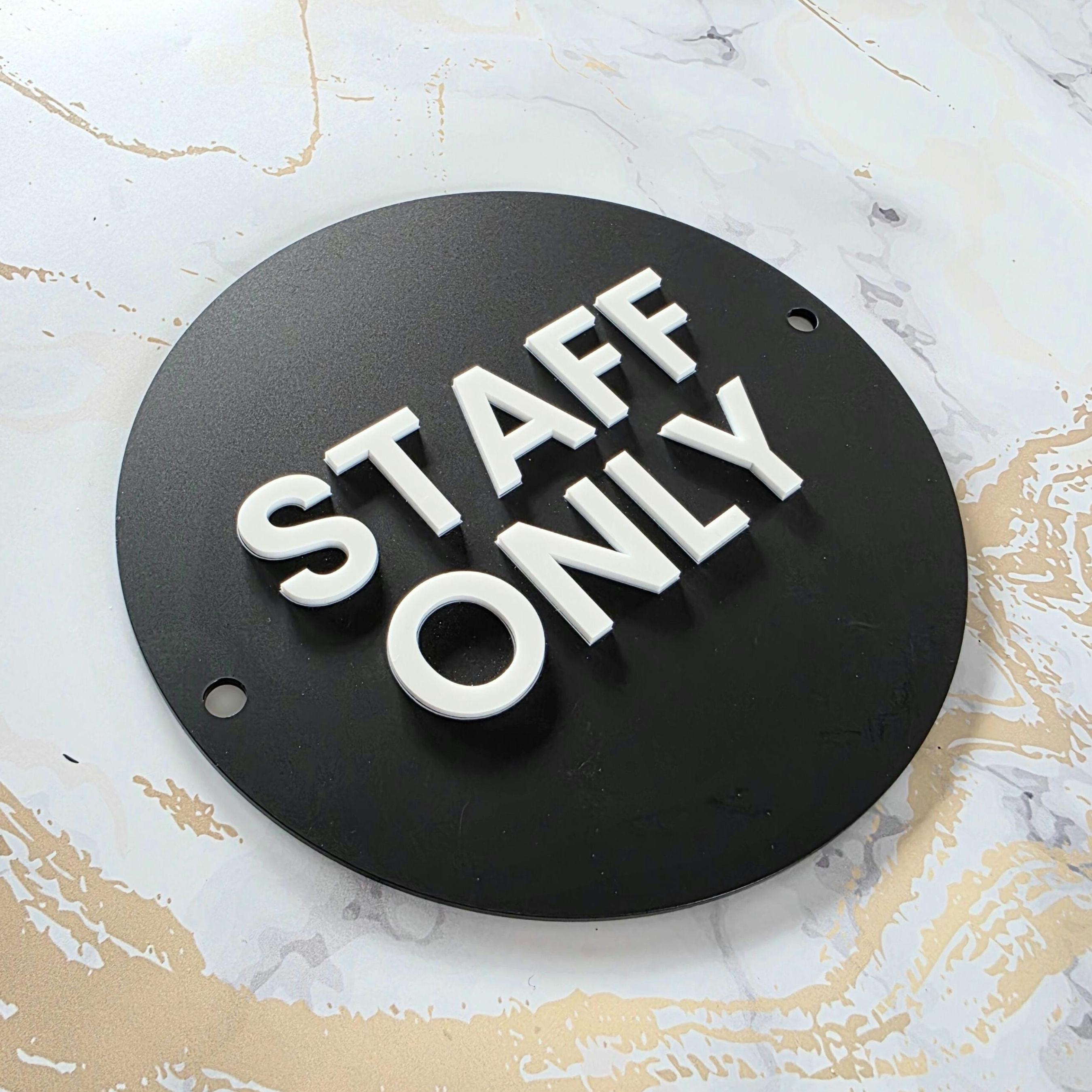 Wall-mounted matte black acrylic STAFF ONLY door sign with a modern white 3D acrylic lettering. Features silver standoff fixings for easy installation. Available in multiple colourways. Ideal for businesses, restaurants, offices, public washrooms