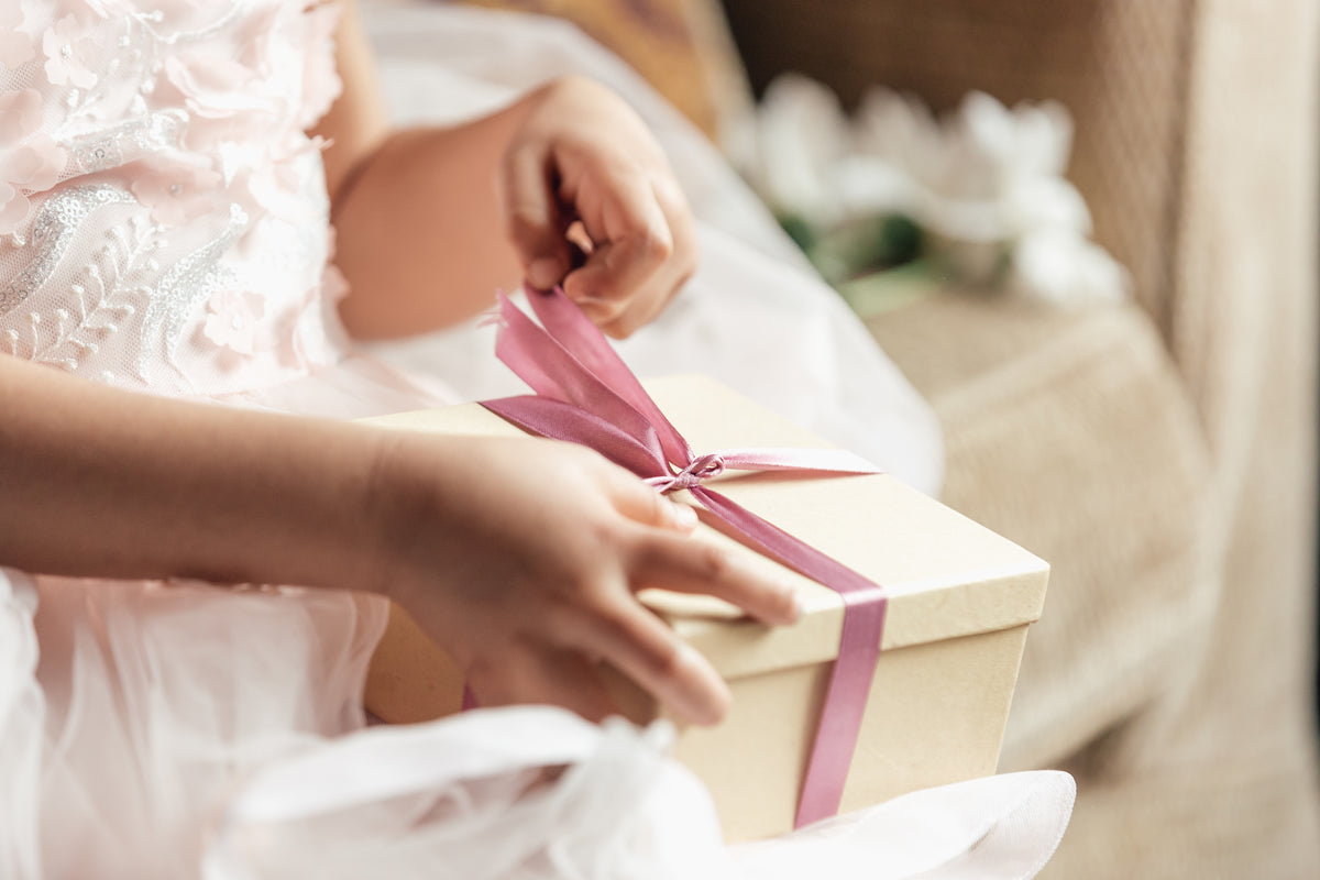 a person opening a wrapped gift in a bright sunny room